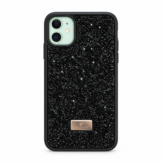 A black phone case covered in tiny reflective rhinestones, with a small rose gold Swarovski brand plaque near the bottom and a light green phone camera cutout visible at the top left, shown on a plain white background.