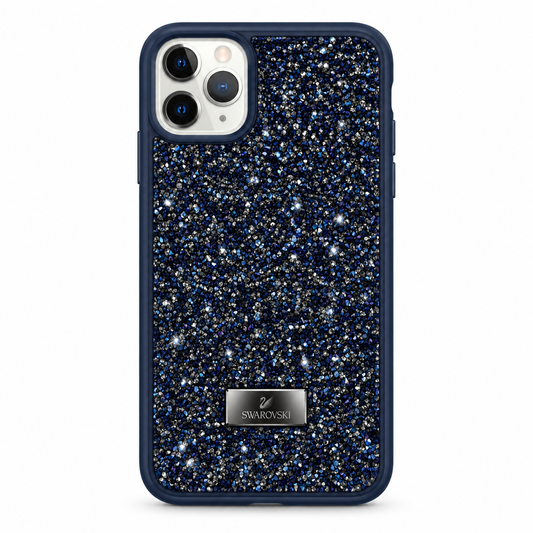 A protective phone case featuring a navy blue border and a back cover covered in dense blue, silver, and white glitter. A silver metal plate with the Swarovski logo is positioned near the bottom.