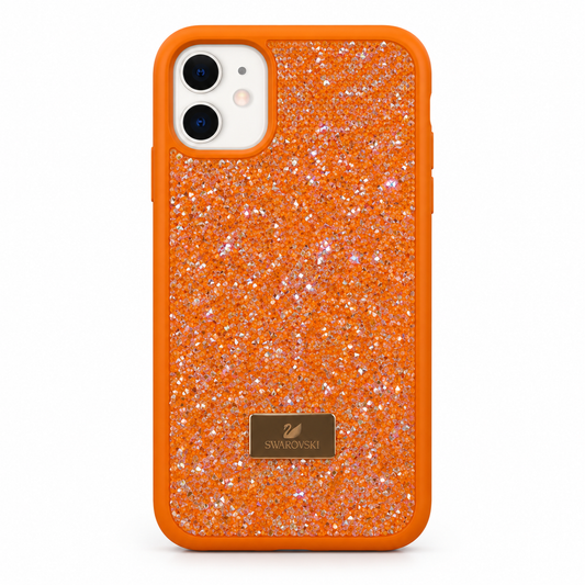 An orange protective phone case covered in fine silver glitter, featuring a gold Swarovski logo plaque on the lower back and a white camera cutout.